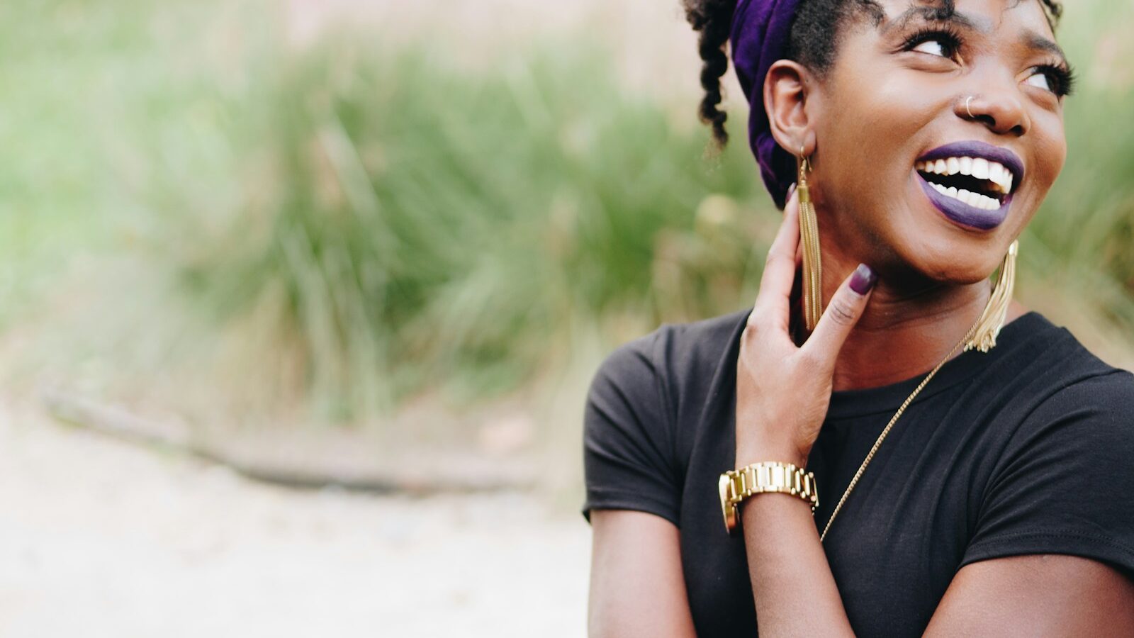 photo of woman wearing purple lipstick and black crew-neck shirt